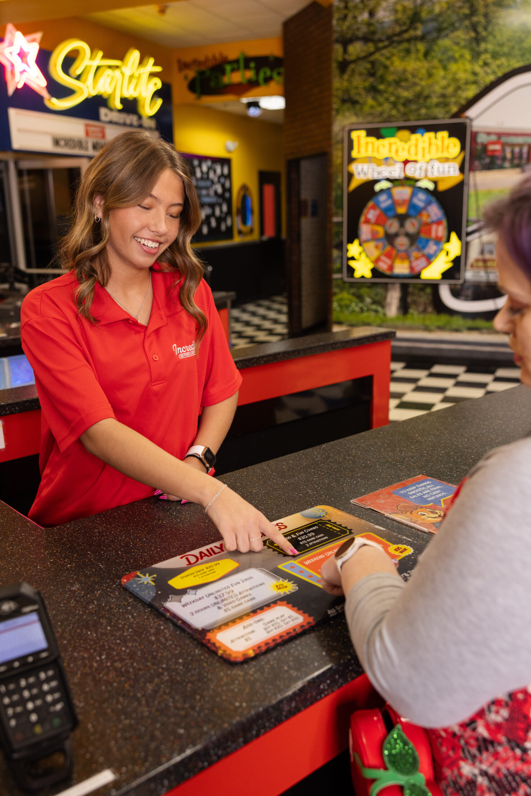Cashier helping guest at Incredible Food & Fun